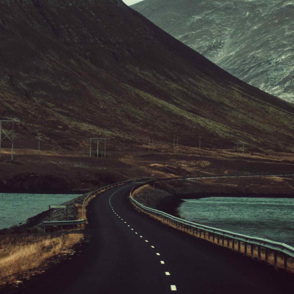 A winding road heading into mountains.